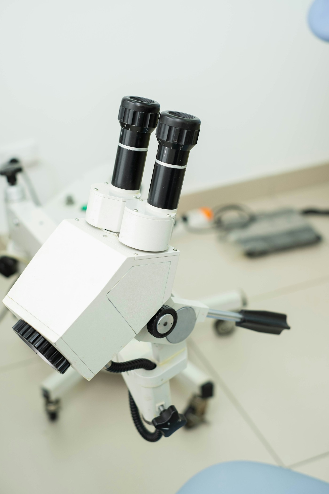 Dental operating microscope on a wheeled stand